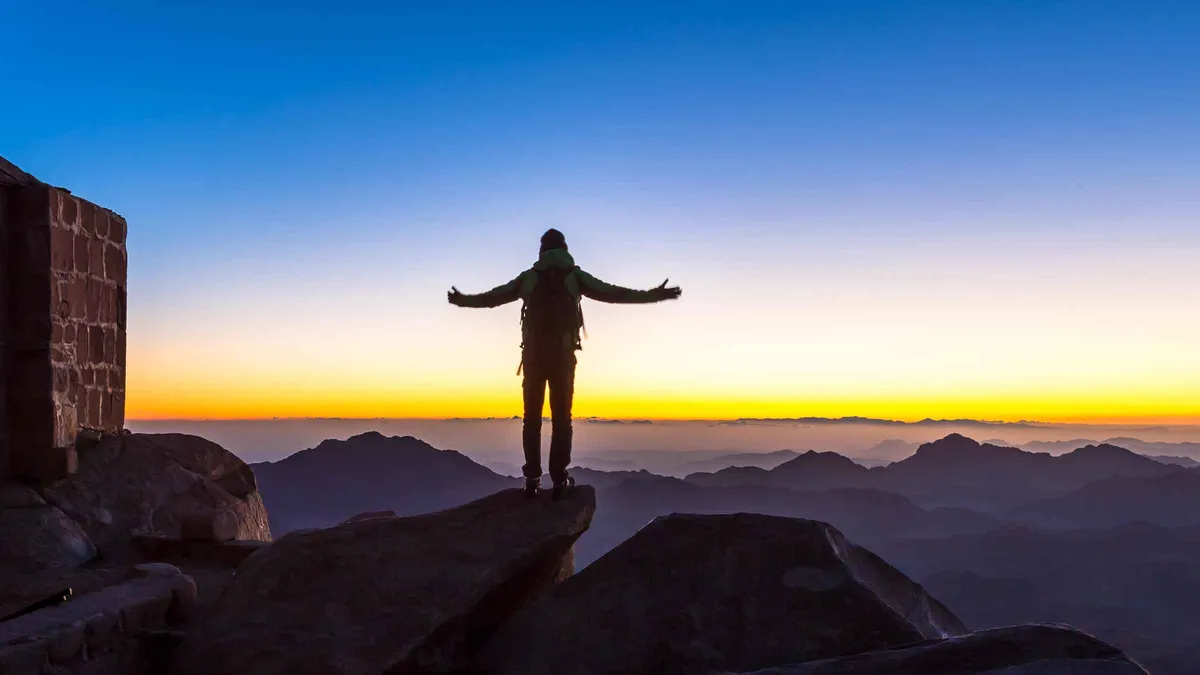 Hikers on the summit of Mount Sinai at sunrise on a St Catherine's Monastery tour from Sharm El Sheikh, Egypt